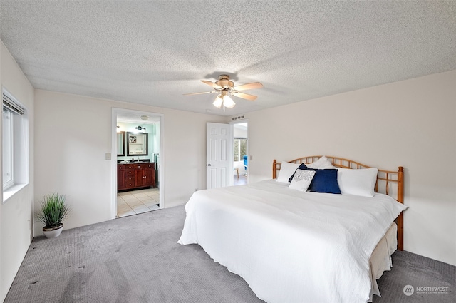 bedroom featuring multiple windows, ceiling fan, and a textured ceiling