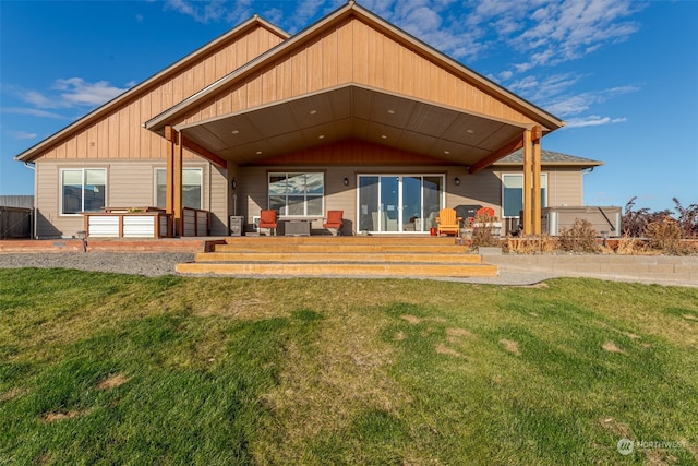 rear view of house featuring a yard