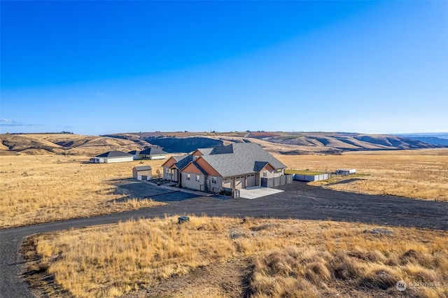 aerial view with a mountain view and a rural view