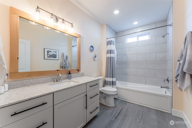 full bathroom with hardwood / wood-style flooring, vanity, toilet, and shower / bath combo with shower curtain