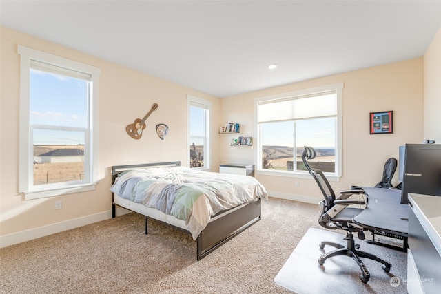 carpeted bedroom featuring multiple windows