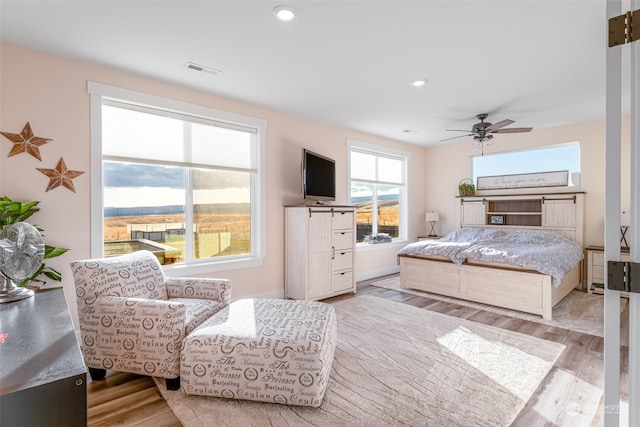 bedroom featuring ceiling fan and light hardwood / wood-style flooring