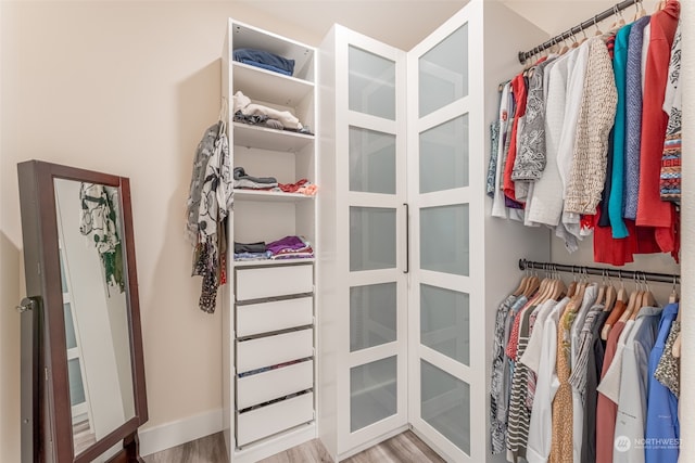 walk in closet featuring light hardwood / wood-style flooring