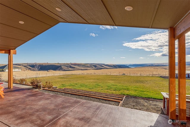 view of patio / terrace with a mountain view and a rural view