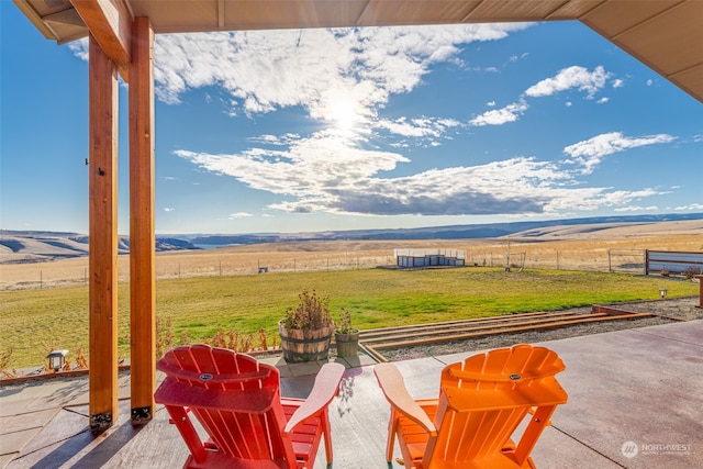 view of patio with a mountain view and a rural view