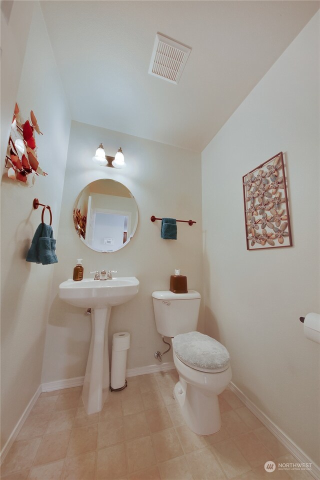 bathroom with tile patterned floors and toilet