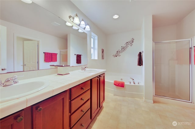 bathroom with vanity and independent shower and bath