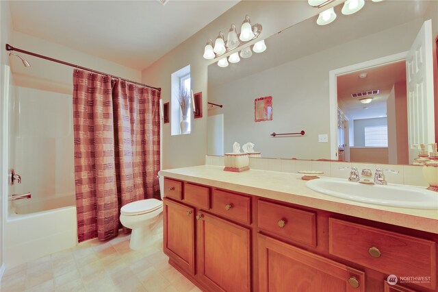 full bathroom with shower / bath combination with curtain, vanity, and toilet