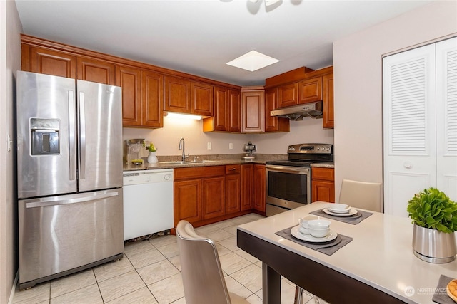 kitchen featuring light tile patterned floors, stainless steel appliances, and sink