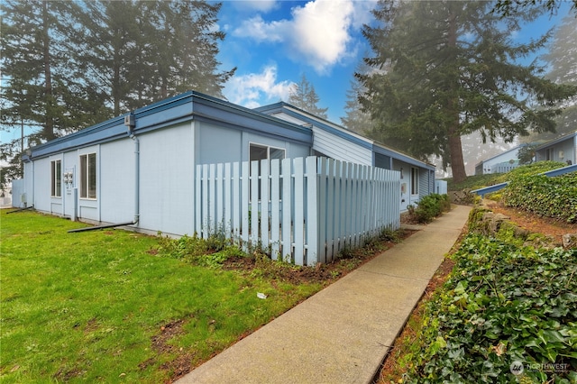 view of side of home featuring a lawn