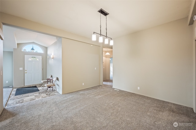 carpeted foyer entrance featuring lofted ceiling