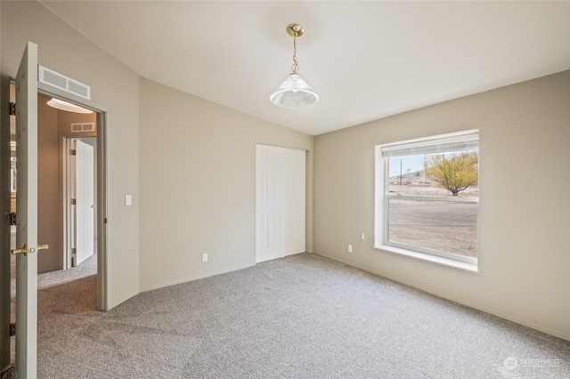 unfurnished room with carpet flooring and vaulted ceiling