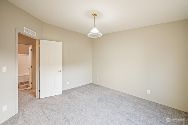 unfurnished room featuring light colored carpet