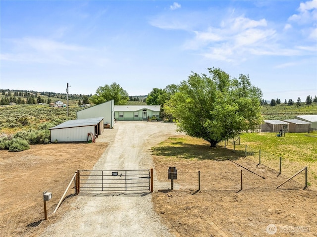 16161 Badger Mountain Rd, East Wenatchee, WA 98802 - view of front of home with a gate, an outbuilding, a view of rural / pastoral area, and dirt driveway