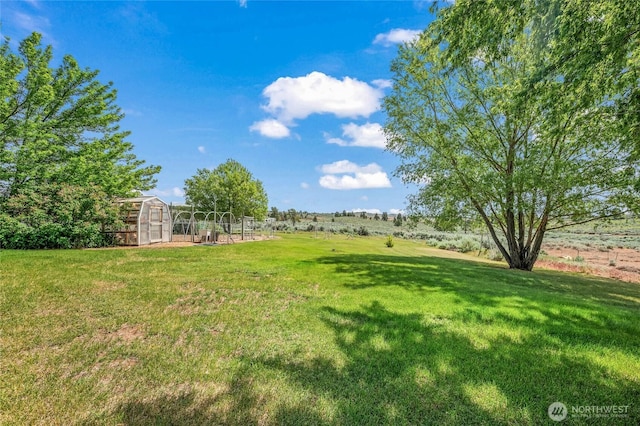 16161 Badger Mountain Rd, East Wenatchee, WA 98802 - view of grassy yard featuring a greenhouse and an outdoor structure