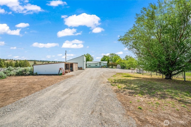 16161 Badger Mountain Rd, East Wenatchee, WA 98802 - view of front of house featuring a pole building, an outbuilding, and driveway