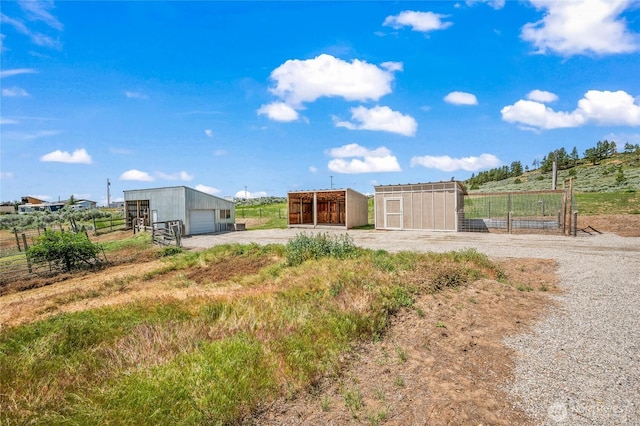 16161 Badger Mountain Rd, East Wenatchee, WA 98802 - view of yard with a pole building, an outbuilding, a detached garage, and a view of countryside