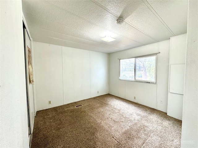 4815 NE Airway Dr Unit 12, Moses Lake, WA 98837 - carpeted spare room featuring a textured ceiling and a smoke detector