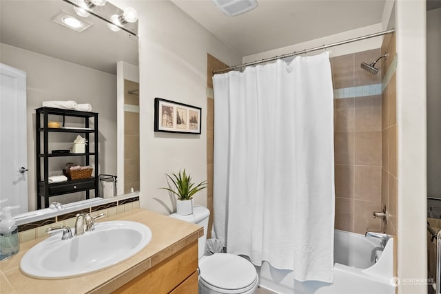 full bathroom featuring vanity, shower / bathtub combination with curtain, and toilet