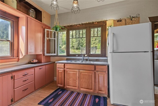 27525 W Lake Riley Rd, Arlington, WA 98223 - kitchen with freestanding refrigerator, a sink, light wood-style floors, and plenty of natural light