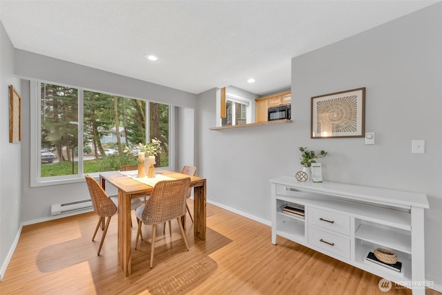 dining area featuring light wood finished floors, recessed lighting, a baseboard radiator, and baseboards