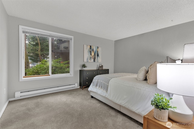 bedroom with a textured ceiling, carpet floors, and baseboard heating