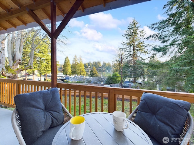 deck featuring outdoor dining area and a grill