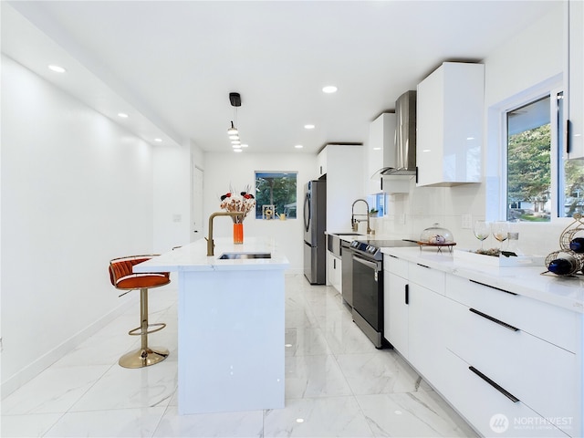 kitchen with electric range, freestanding refrigerator, a sink, wall chimney range hood, and modern cabinets