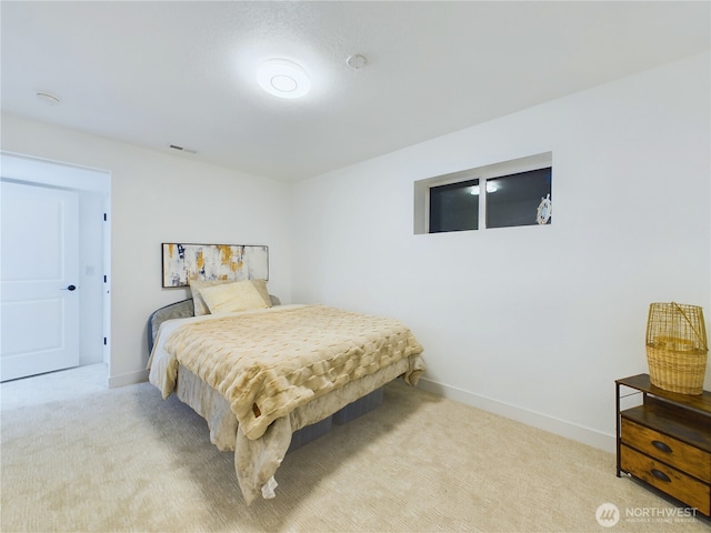 carpeted bedroom with visible vents and baseboards