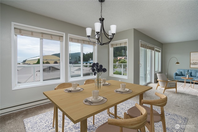 carpeted dining space featuring a chandelier, a textured ceiling, and baseboard heating