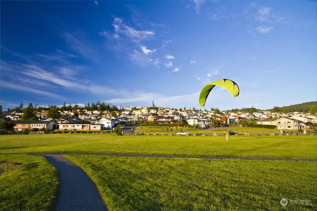 view of property's community featuring a yard