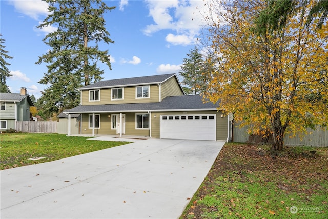 view of front of property with a front yard, a porch, and a garage