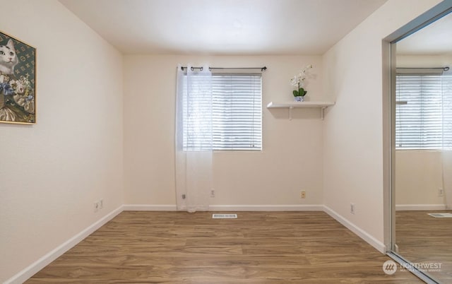 spare room with hardwood / wood-style floors