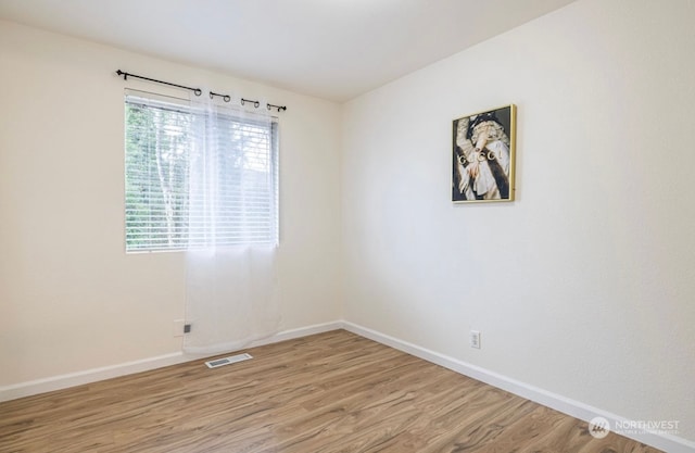 unfurnished room featuring wood-type flooring