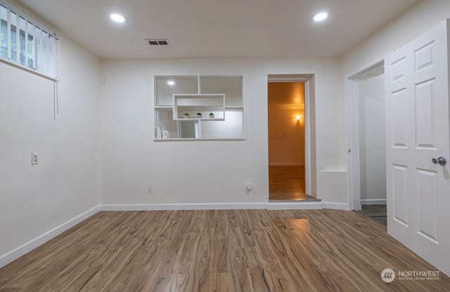 unfurnished room with hardwood / wood-style flooring