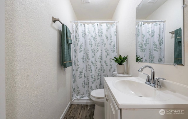 bathroom featuring a shower with shower curtain, vanity, wood-type flooring, and toilet