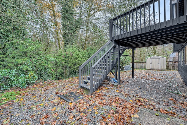 view of yard with a wooden deck and a storage unit