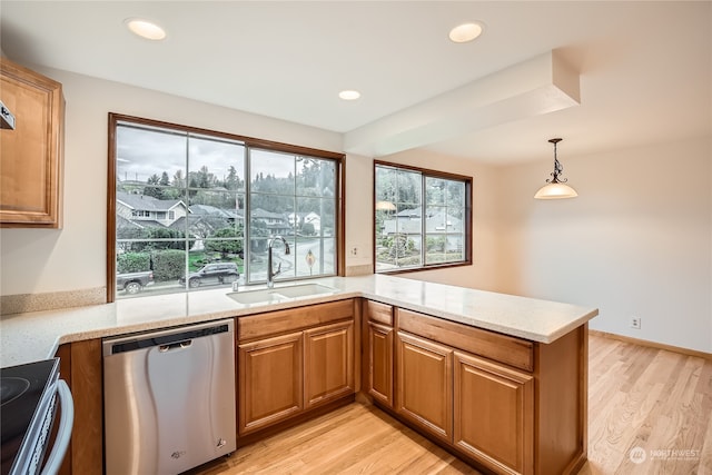 kitchen featuring a wealth of natural light, sink, light hardwood / wood-style flooring, and appliances with stainless steel finishes