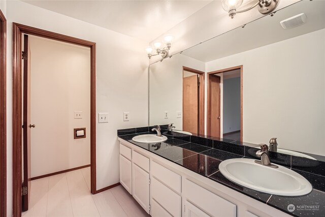 bathroom featuring tile patterned floors and vanity