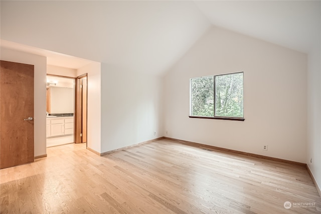 interior space with light hardwood / wood-style floors and vaulted ceiling