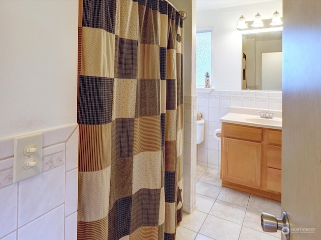 bathroom featuring tile patterned flooring, a shower with curtain, vanity, and tile walls