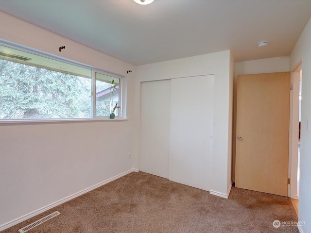 unfurnished bedroom featuring a closet and carpet