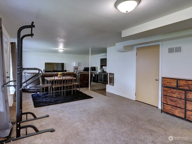 dining area with carpet floors and a textured ceiling