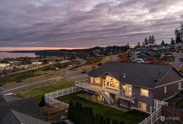 aerial view at dusk with a water view