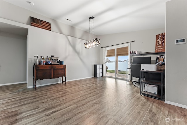 office featuring hardwood / wood-style floors and lofted ceiling