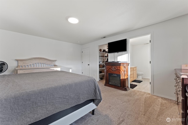 carpeted bedroom featuring connected bathroom