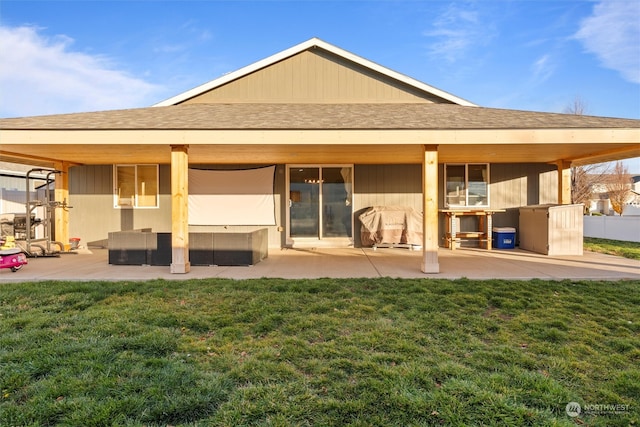 back of house with outdoor lounge area, a patio area, and a lawn