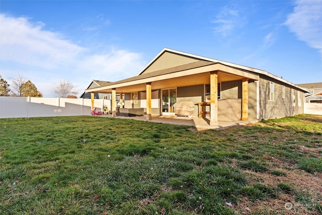 back of property featuring outdoor lounge area, a patio area, and a lawn