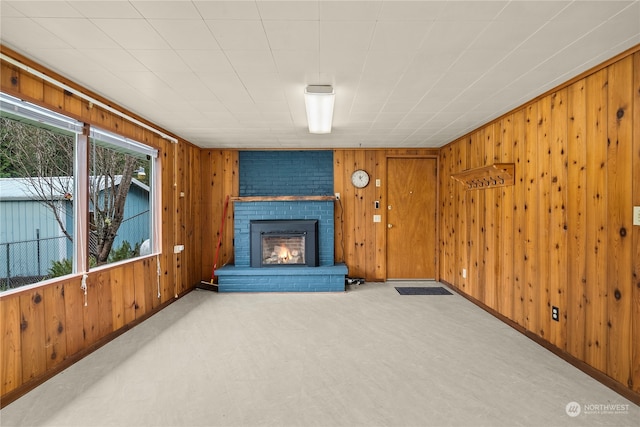 living room with a fireplace and wooden walls