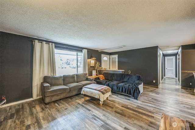 living room featuring hardwood / wood-style floors and a textured ceiling